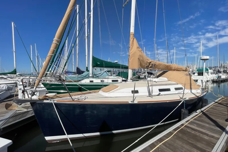 Slide: The Image of 2001 J Boats J/32 sailboat docked at marina under clear blue sky. - 2