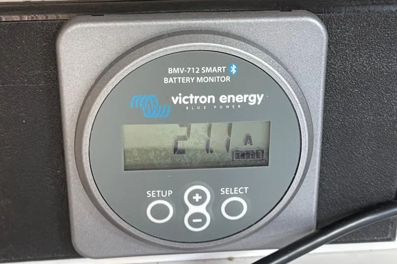 Slide: The Image of Victron Energy BMV-712 battery monitor displaying 21.1A on a 2001 J Boats J/32. - 26