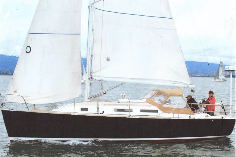 Slide: The Image of 2001 J Boats J/32 sailing on calm waters with crew onboard. - 29