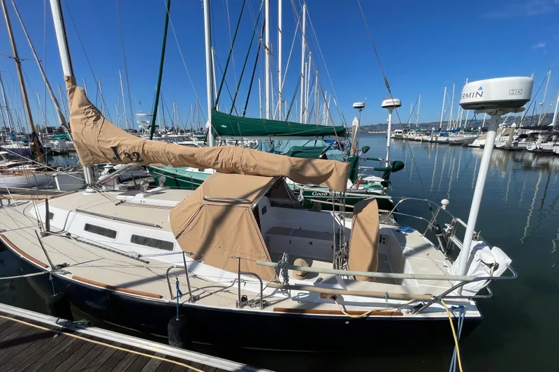 Slide: The Image of 2001 J Boats J/32 sailboat docked at a marina under clear blue skies. - 3