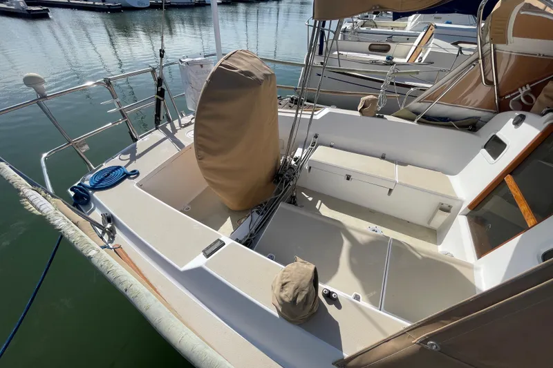 Slide: The Image of 2001 J Boats J/32 sailboat cockpit with covered wheel, docked in marina. - 6