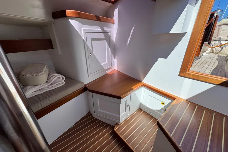 Slide: The Image of Interior of 2018 Leonardo Yachts Eagle 44, featuring wooden accents and cozy seating area. - 20