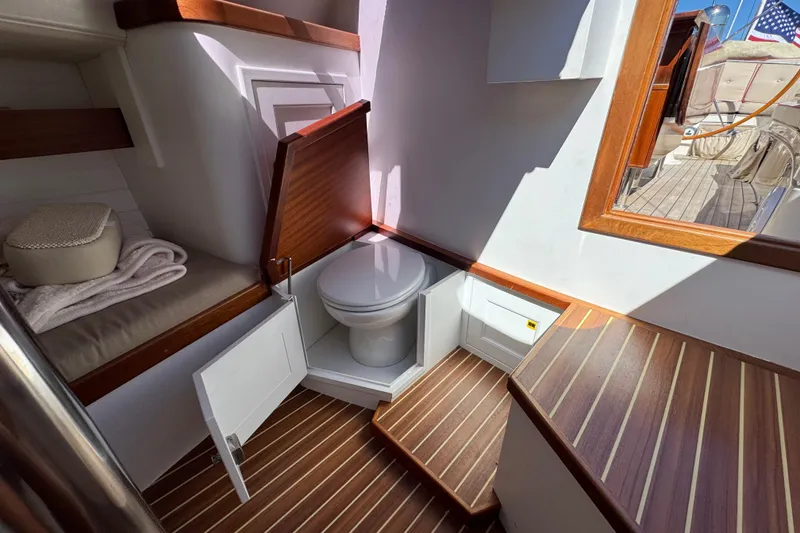Slide: The Image of Interior of 2018 Leonardo Yachts Eagle 44, featuring a compact bathroom with wooden accents. - 21
