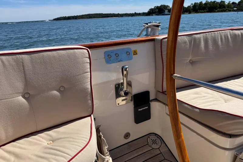 Slide: The Image of 2018 Leonardo Yachts Eagle 44 interior with cushioned seating and wooden steering wheel. - 14