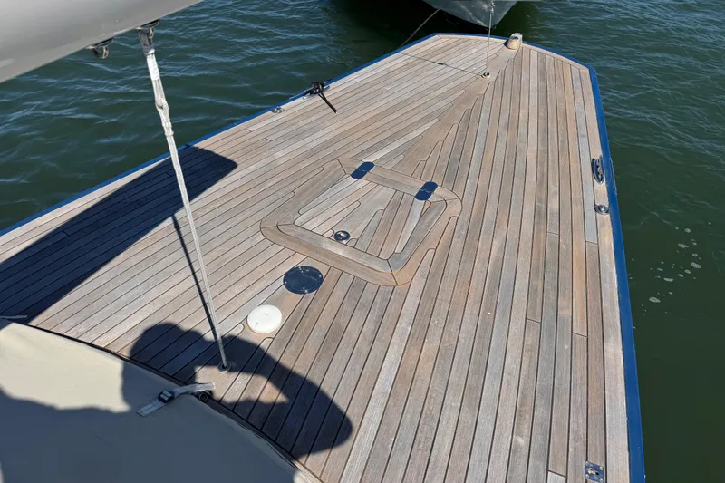 Slide: The Image of Deck of 2018 Leonardo Yachts Eagle 44, featuring sleek wooden design on calm water. - 6