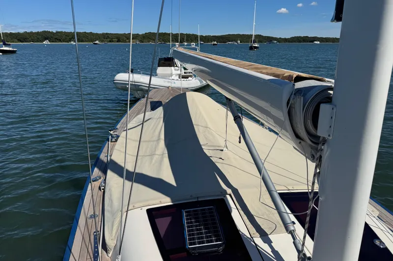 Slide: The Image of 2018 Leonardo Yachts Eagle 44 sailboat on calm water, featuring a covered deck. - 9