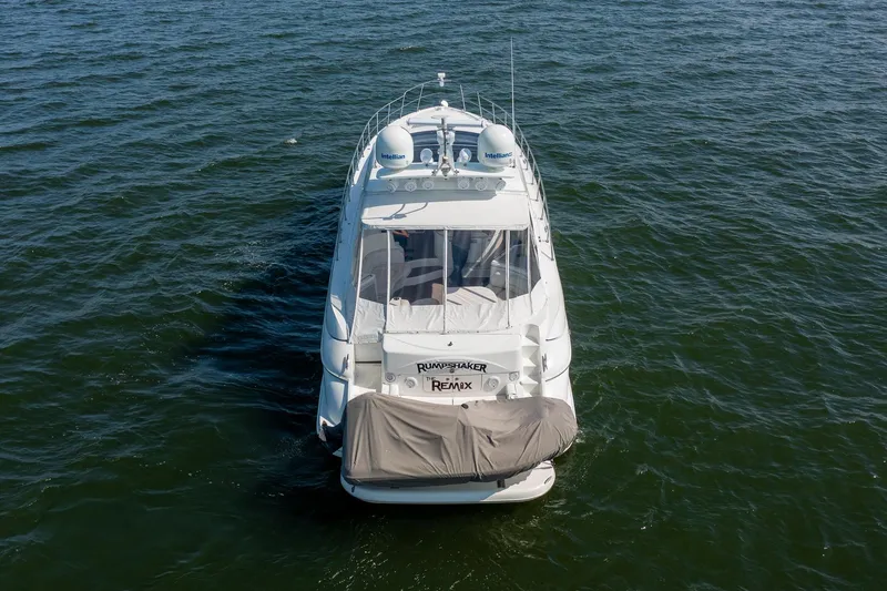 Slide: The Image of 2002 Cruisers 5370 yacht on open water, aerial rear view. - 1