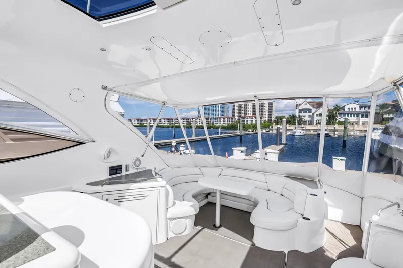 Slide: The Image of Luxurious 2002 Cruisers 5370 yacht interior with waterfront view and elegant seating area. - 12