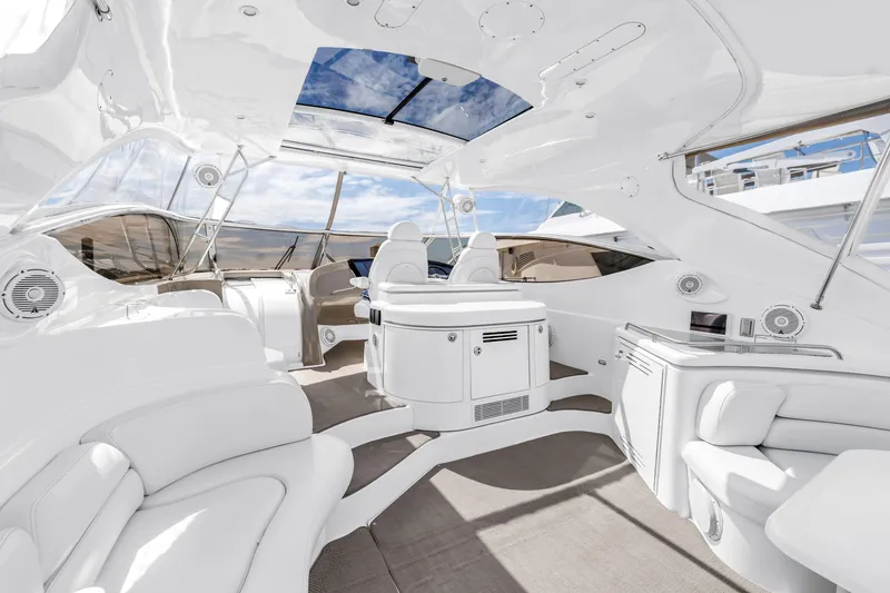 Slide: The Image of Luxurious 2002 Cruisers 5370 yacht interior with sleek white seating and modern amenities. - 13