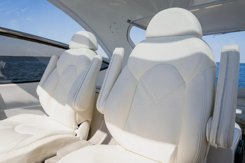 Slide: The Image of Luxurious white leather seats on a 2002 Cruisers 5370 yacht, ocean view. - 16