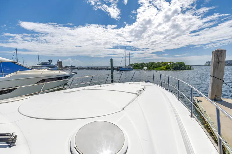 Slide: The Image of 2002 Cruisers 5370 yacht docked at marina with scenic ocean view. - 17