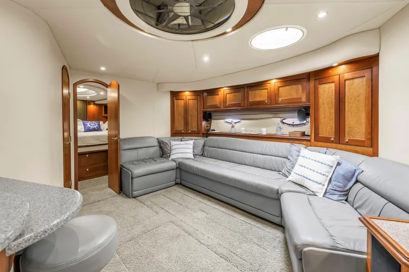 Slide: The Image of Luxurious 2002 Cruisers 5370 yacht interior with elegant seating and wooden cabinetry. - 23