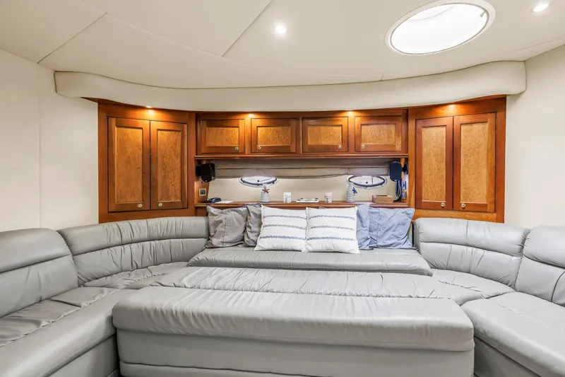 Slide: The Image of Luxurious 2002 Cruisers 5370 yacht interior with plush seating and elegant wood cabinetry. - 24