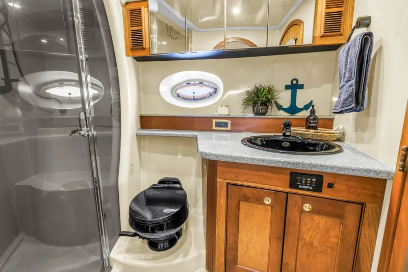 Slide: The Image of Luxurious 2002 Cruisers 5370 yacht bathroom with modern amenities and nautical decor. - 30