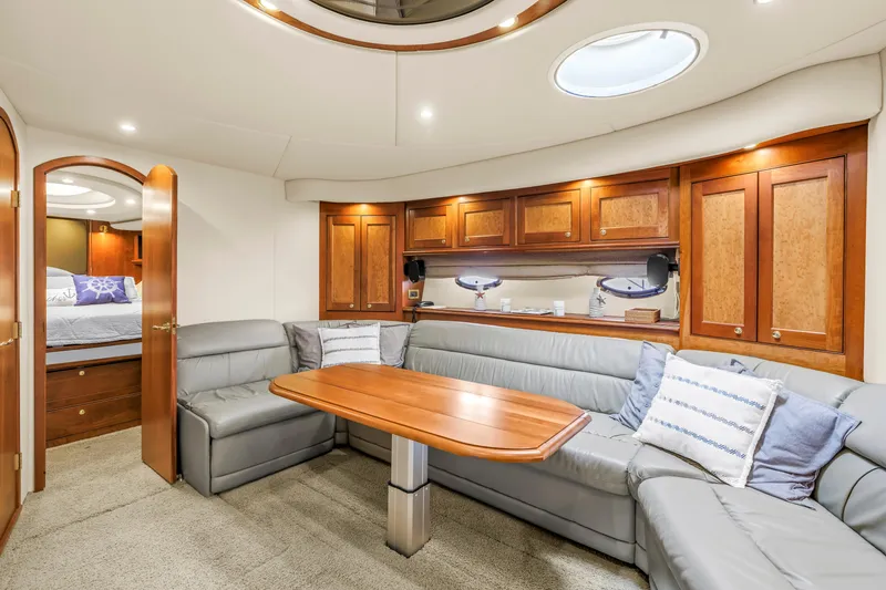 Slide: The Image of Luxurious 2002 Cruisers 5370 yacht interior with elegant wood cabinetry and plush seating. - 31