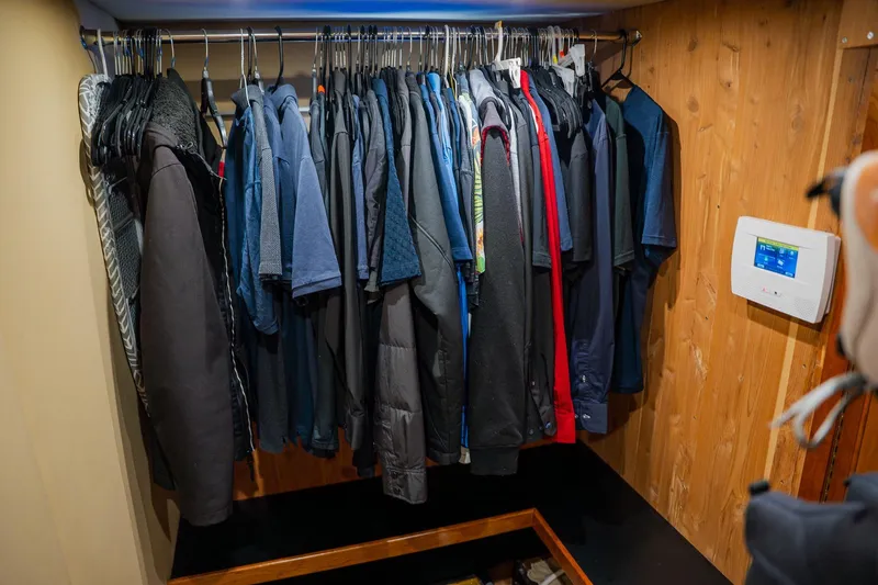 Slide: The Image of Clothing closet in 2002 Cruisers 5370 yacht with wooden paneling and control panel. - 35