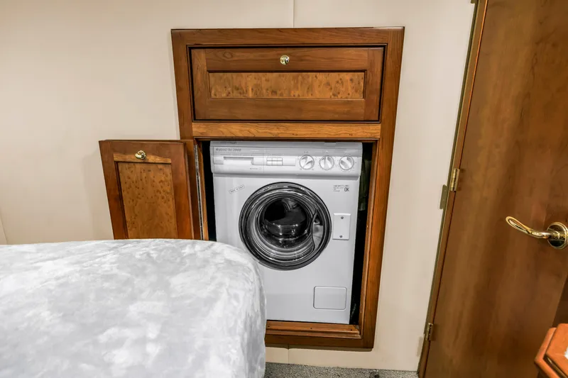 Slide: The Image of Built-in washing machine in wooden cabinet on 2002 Cruisers 5370 yacht. - 38
