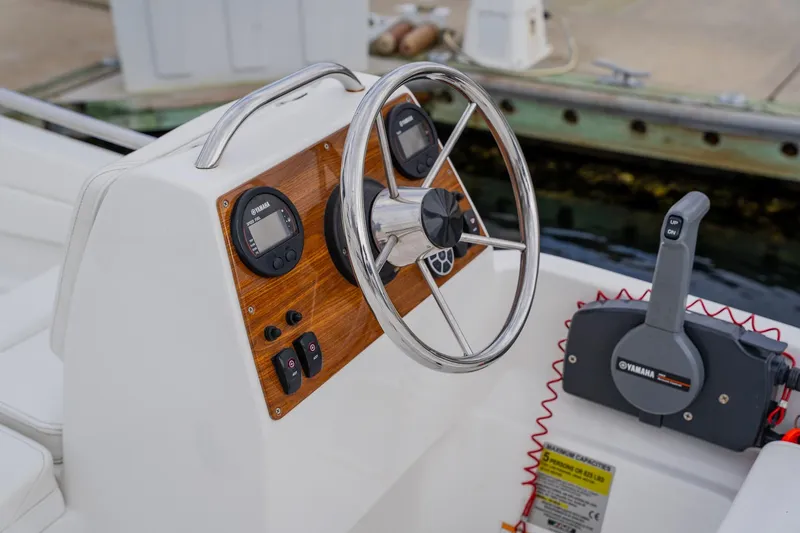 Slide: The Image of Steering console of 2002 Cruisers 5370 boat with Yamaha controls and gauges. - 40