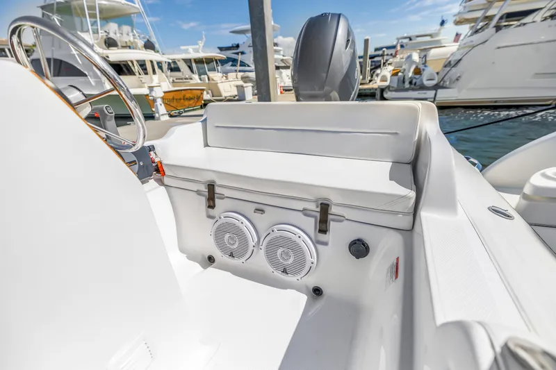 Slide: The Image of Interior of 2002 Cruisers 5370 boat with seating and speakers at a marina. - 41