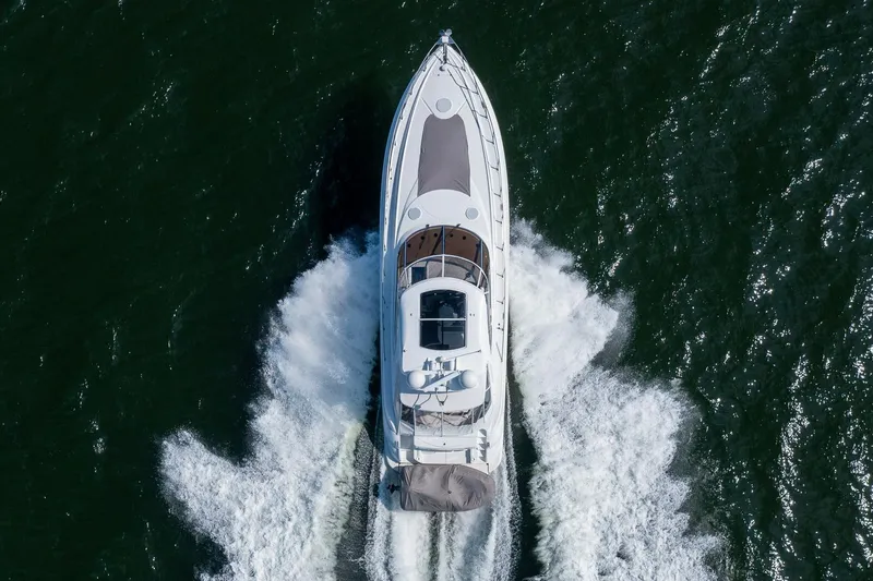 Slide: The Image of Aerial view of 2002 Cruisers 5370 yacht cruising on open water. - 6