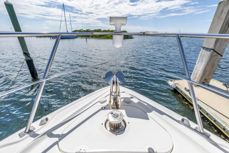 Slide: The Image of Bow view of 2002 Cruisers 5370 yacht on calm water under blue sky. - 18