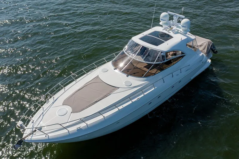 Slide: The Image of 2002 Cruisers 5370 yacht on open water, showcasing sleek design and luxury features. - 2