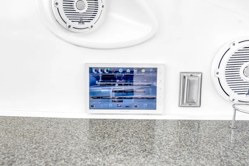 Slide: The Image of Control panel and speakers on a 2002 Cruisers 5370 yacht dashboard. - 21