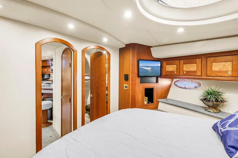 Slide: The Image of Luxurious 2002 Cruisers 5370 yacht interior with wood accents and modern amenities. - 26