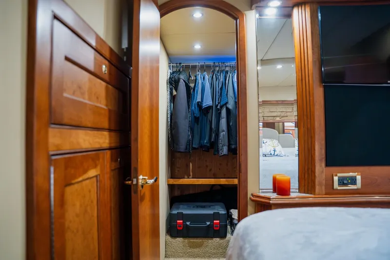 Slide: The Image of Luxurious 2002 Cruisers 5370 yacht interior with wooden closet and cozy bedroom. - 36