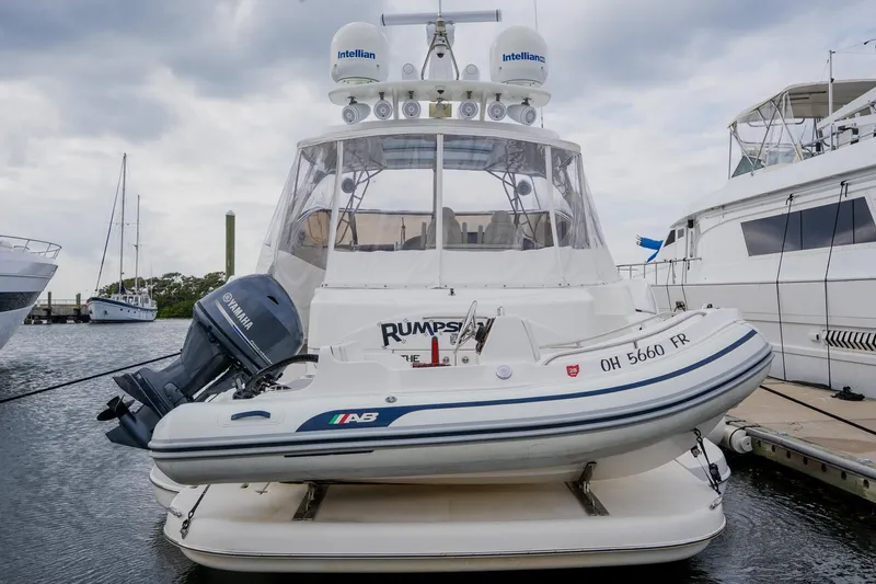 Slide: The Image of 2002 Cruisers 5370 yacht docked with inflatable boat and Yamaha motor. - 8