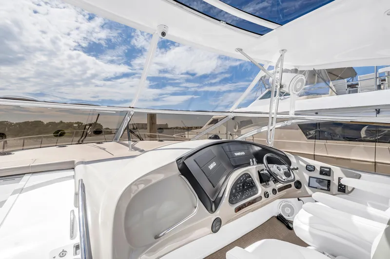Slide: The Image of Helm of 2002 Cruisers 5370 yacht with modern navigation equipment and panoramic views. - 9