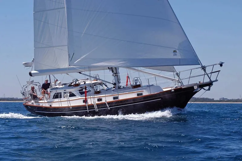 The Image of 2004 Cabo Rico 42 sailboat cruising on open water under clear skies. - 0