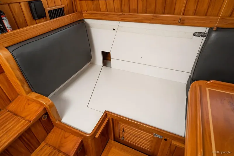 Slide: The Image of Interior of 2005 Cabo Rico 42 Pilot yacht with wooden finish and seating area. - 10