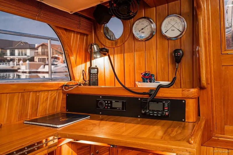 Slide: The Image of Interior of 2005 Cabo Rico 42 Pilot with wooden paneling and navigation equipment. - 12
