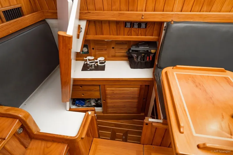 Slide: The Image of Interior of 2005 Cabo Rico 42 Pilot, featuring wooden cabinetry and seating area. - 13