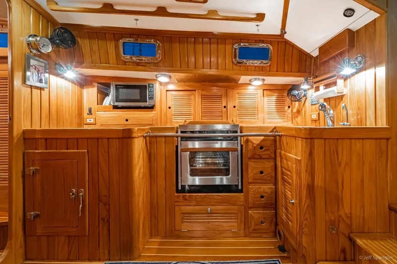 Slide: The Image of Luxurious wooden interior of 2005 Cabo Rico 42 Pilot yacht kitchen. - 15