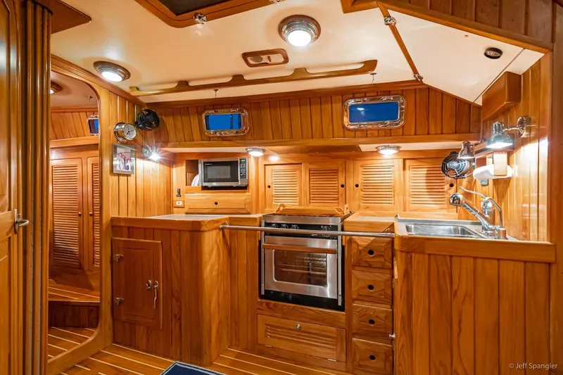 Slide: The Image of Luxurious wooden interior of 2005 Cabo Rico 42 Pilot yacht kitchen. - 16