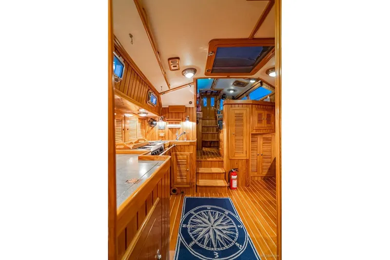 Slide: The Image of Luxurious 2005 Cabo Rico 42 Pilot yacht interior with wooden finishes and nautical decor. - 17