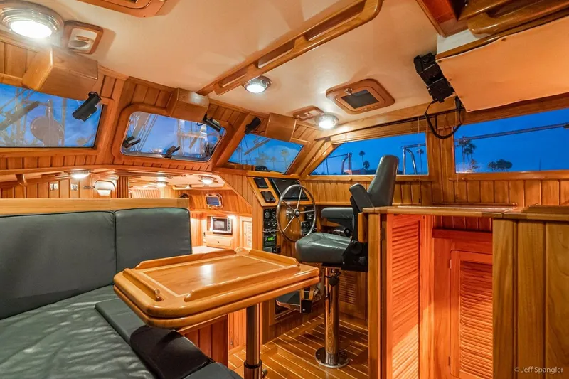 Slide: The Image of Luxurious 2005 Cabo Rico 42 Pilot yacht interior with wooden finish and steering wheel. - 2
