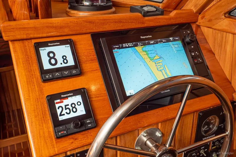 Slide: The Image of Helm of 2005 Cabo Rico 42 Pilot with Raymarine navigation displays and steering wheel. - 20