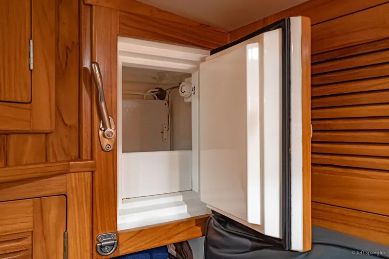 Slide: The Image of Open refrigerator in 2005 Cabo Rico 42 Pilot yacht, showcasing wooden cabinetry. - 22