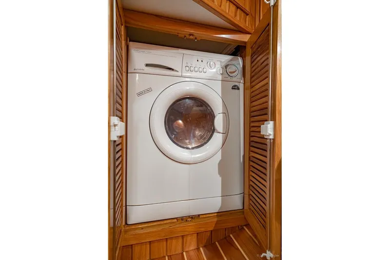 Slide: The Image of Washing machine in wooden cabinet aboard 2005 Cabo Rico 42 Pilot yacht. - 23