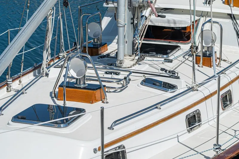 Slide: The Image of 2005 Cabo Rico 42 Pilot yacht deck with polished fittings and open hatch. - 24