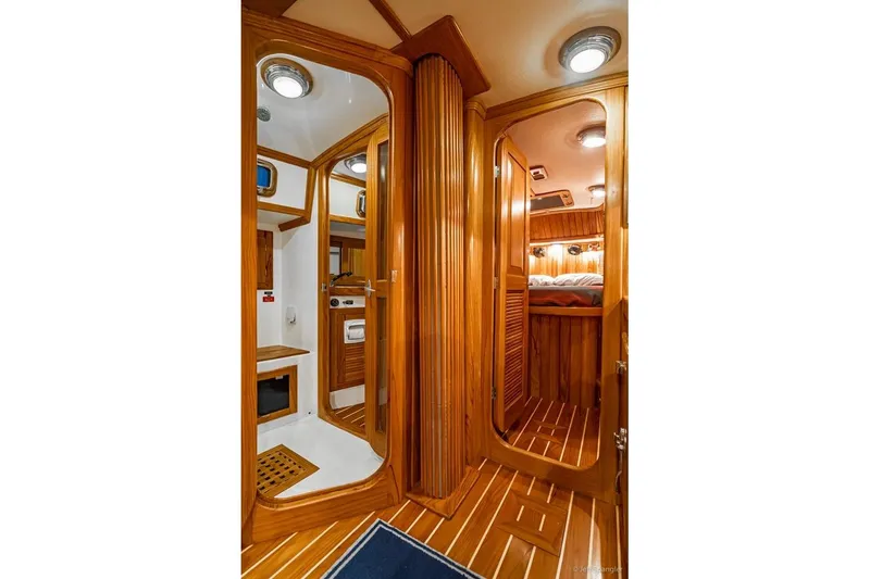 Slide: The Image of Luxurious 2005 Cabo Rico 42 Pilot yacht interior with wood finish and cozy cabin. - 27