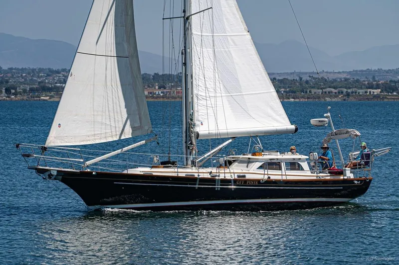 Slide: The Image of 2005 Cabo Rico 42 Pilot sailboat cruising on calm waters with crew onboard. - 31