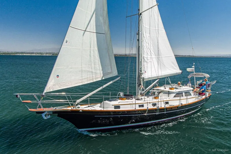 Slide: The Image of 2005 Cabo Rico 42 Pilot sailboat cruising on open water under clear skies. - 32