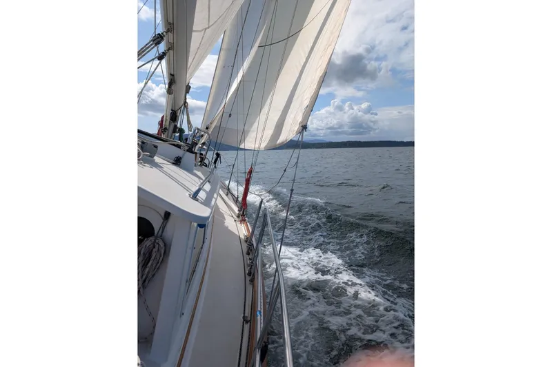 Slide: The Image of Sailing on a 2004 Cabo Rico 42 yacht with full sails on open water. - 33