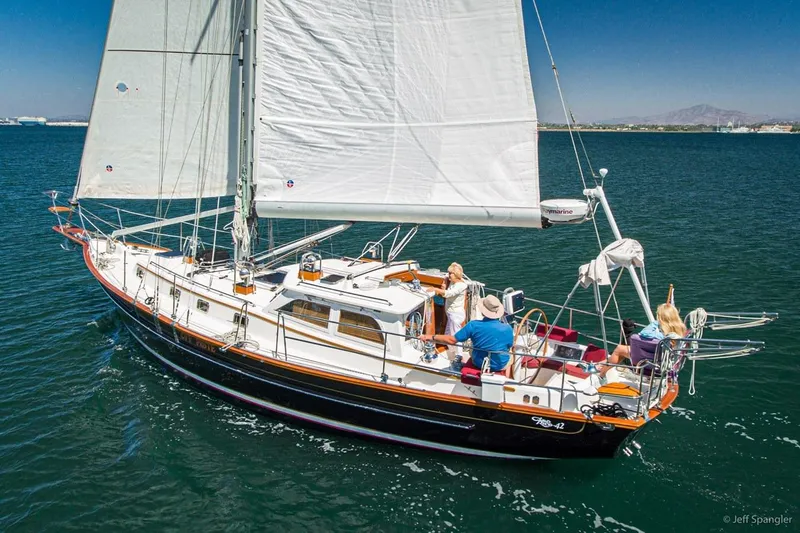 Slide: The Image of 2005 Cabo Rico 42 Pilot sailboat cruising on open water under clear skies. - 34