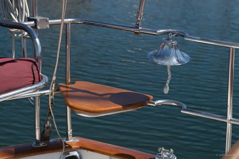 Slide: The Image of Cabo Rico 42 Pilot 2005 yacht detail with bell and wooden seat by water. - 7