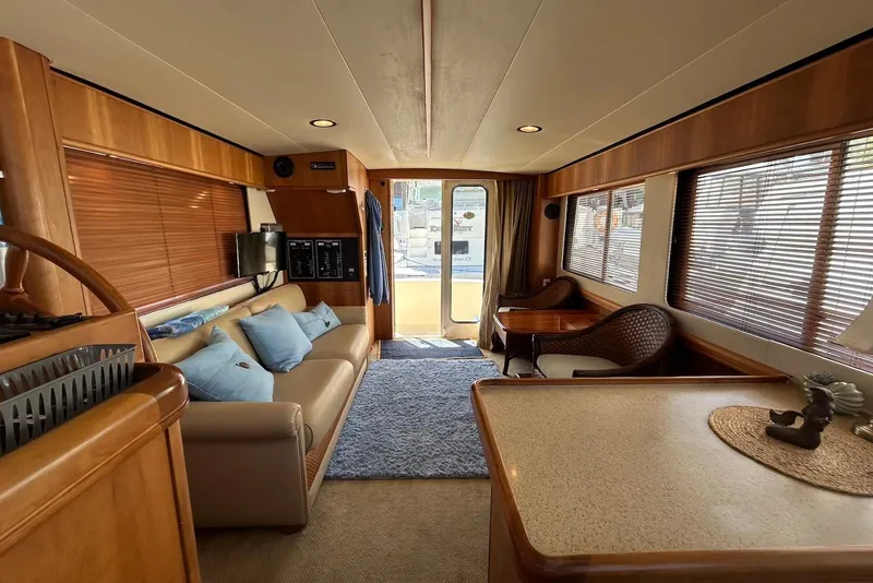 Slide: The Image of Interior of 2007 Mainship 34 Trawler with cozy seating and elegant wood finishes. - 7